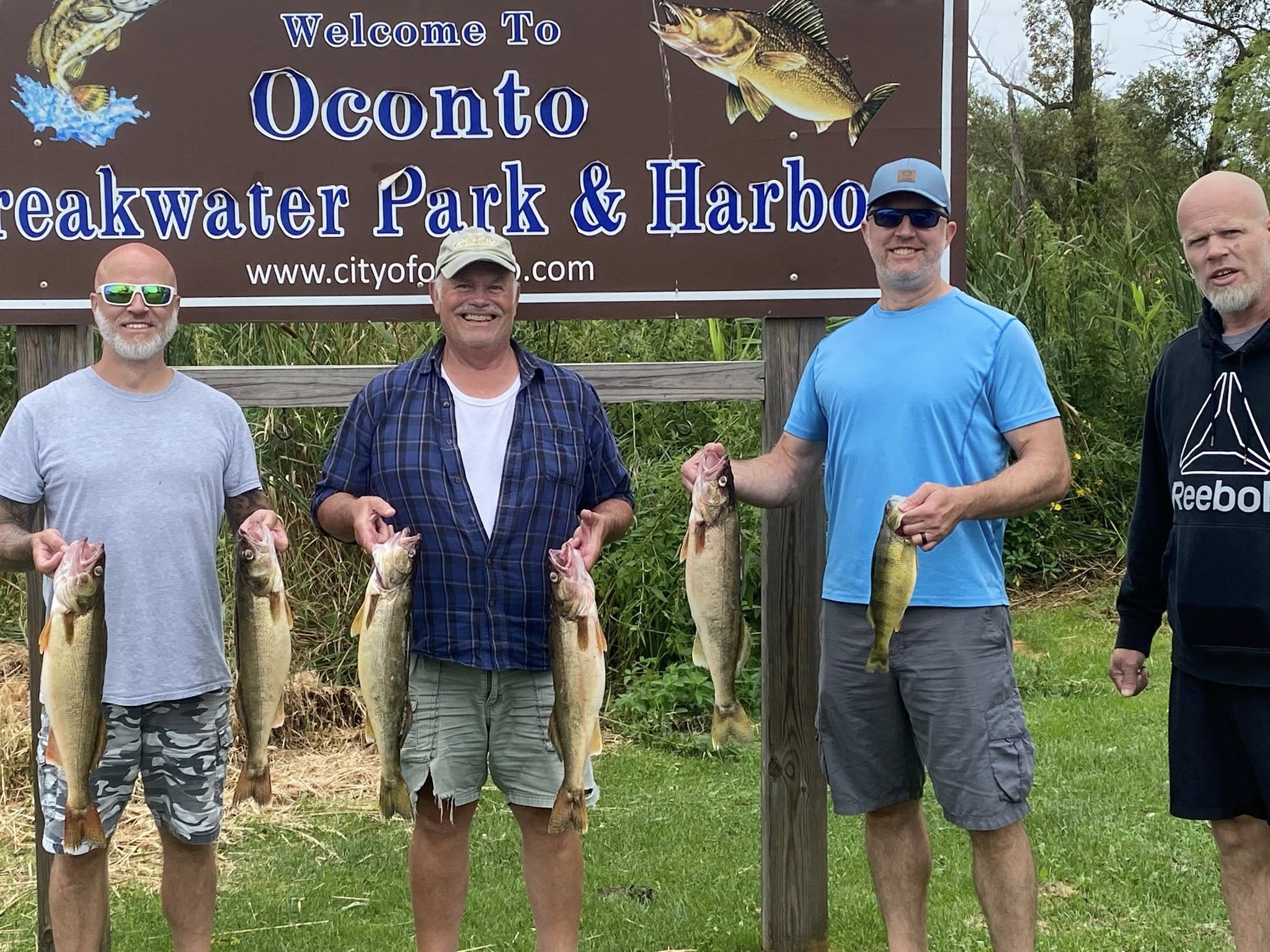 Four clients holding a limit of walleye at Oconto Breakwater Park