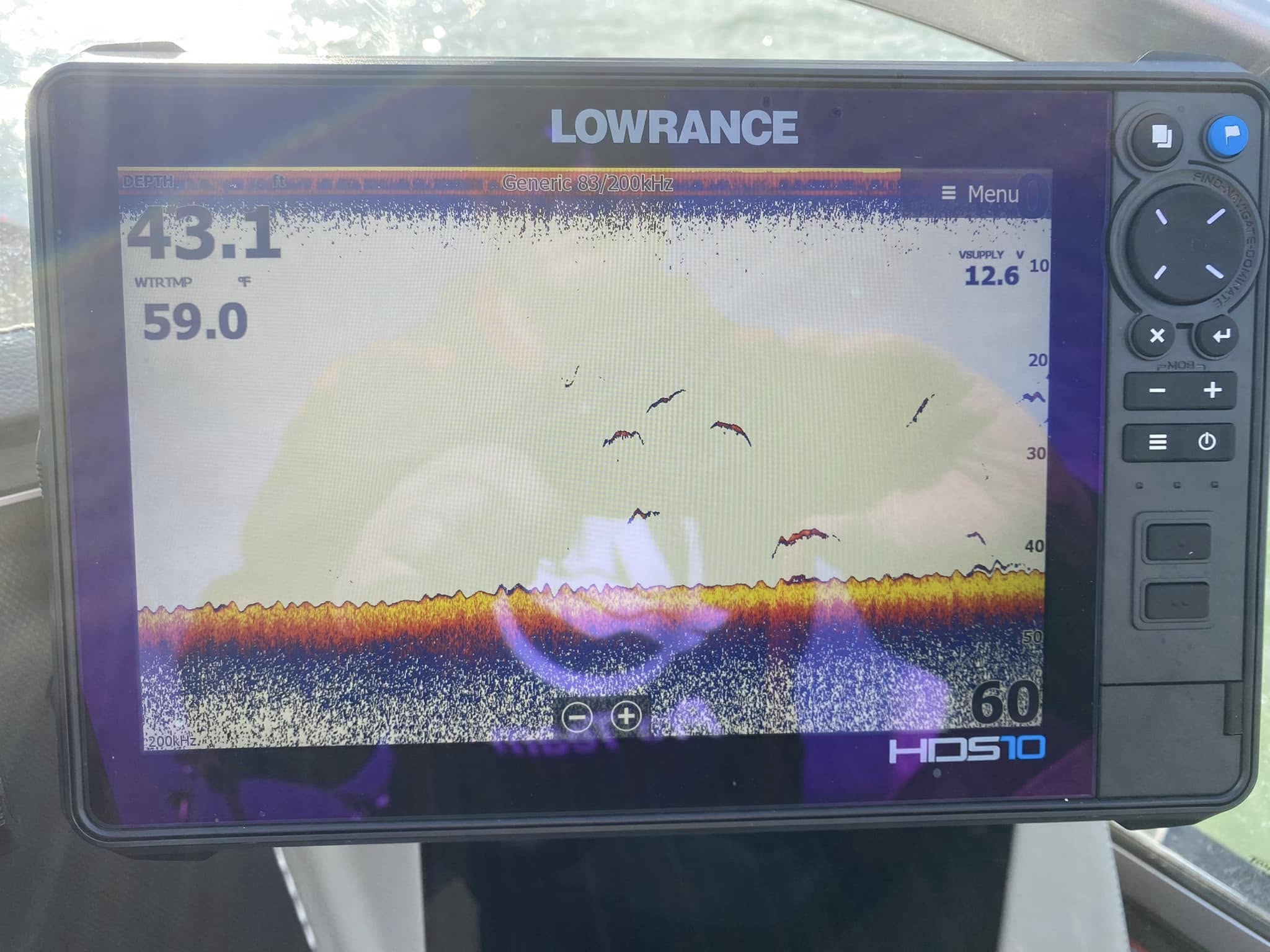 Lowrance fish finder showing fish marks on the screen