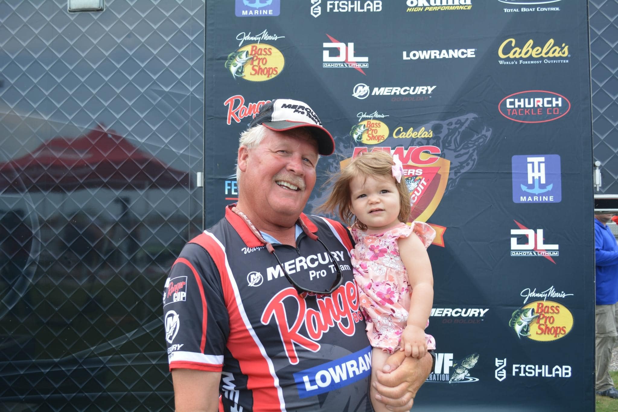 Wayne Butz with his granddaughter at a fishing tournament