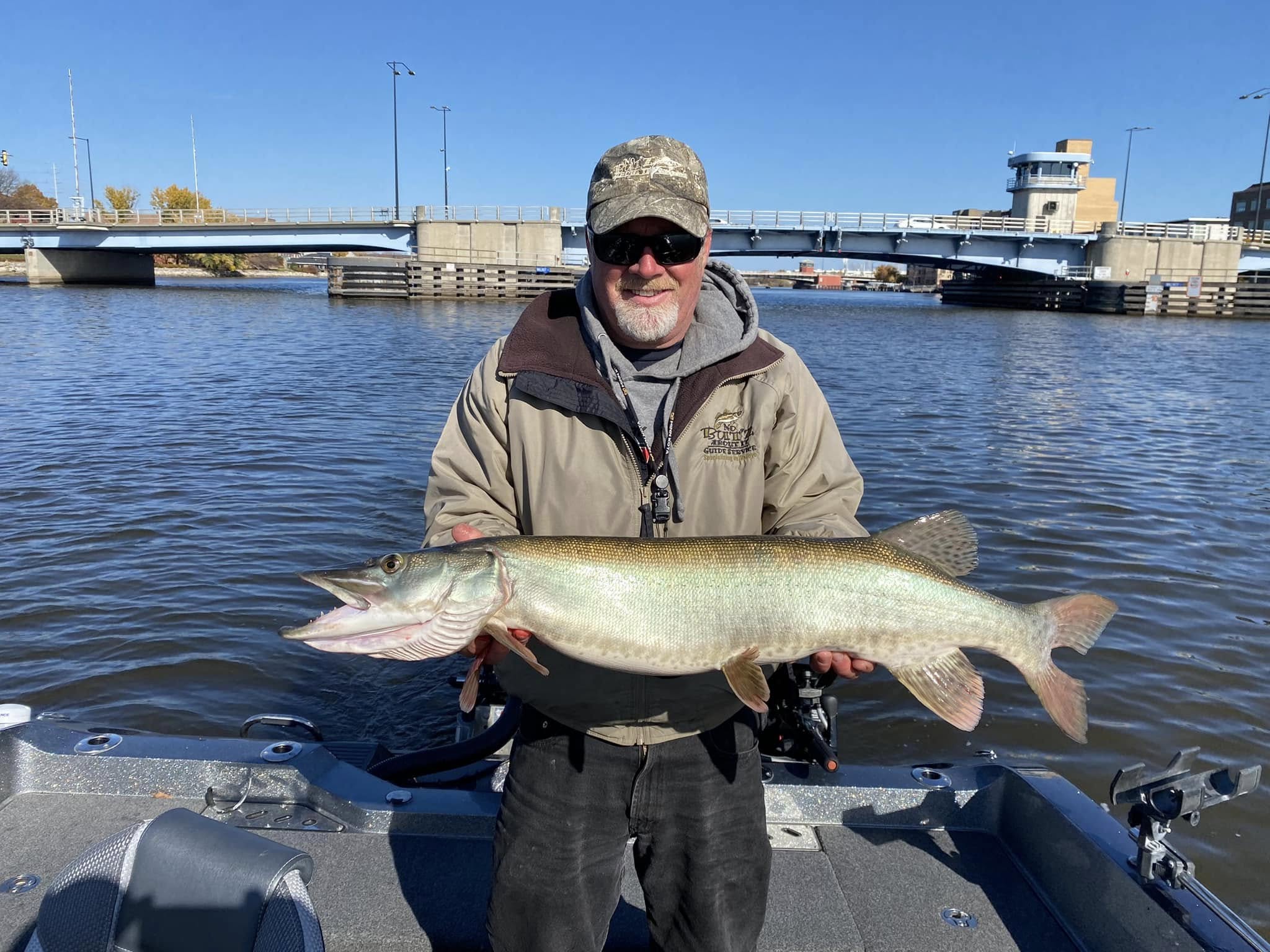 Wayne Butz holding a large muskie on the Bay of Green Bay